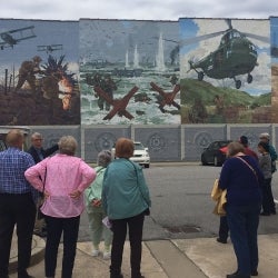 Image of trip participants viewing the decorative wall murals at the Veteran's museum in Tarboro, NC